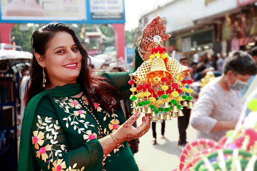 Cheerful pretty women of Indian ethnicity shopping in market during Merry Christmas festival in India portrait close up outdoor in flea market.