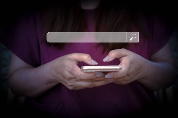 istock Hand of woman working with mobile phone. Searching Browsing Internet Data Information with blank search bar.Search Engine Optimization SEO Networking Concept. 1437742014