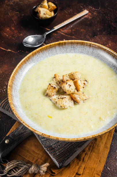 istock Leek soup Vichyssoise with croutons. Dark background. Top view 1437743221
