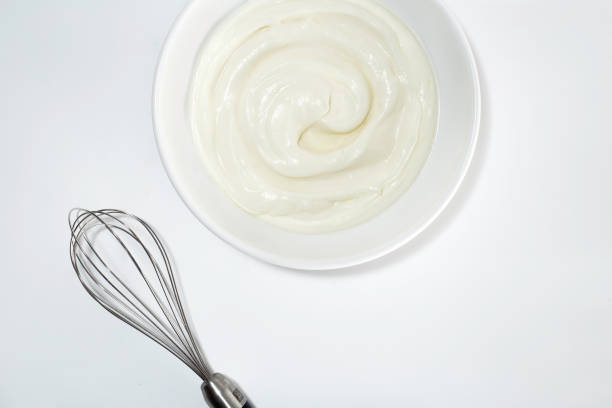 istock Whipped cream with a whisk on a white background 1437743778