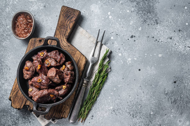 istock Grilled Sauteed Diced Beef in a skillet with garlic. Gray background. Top view. Copy space 1437746732