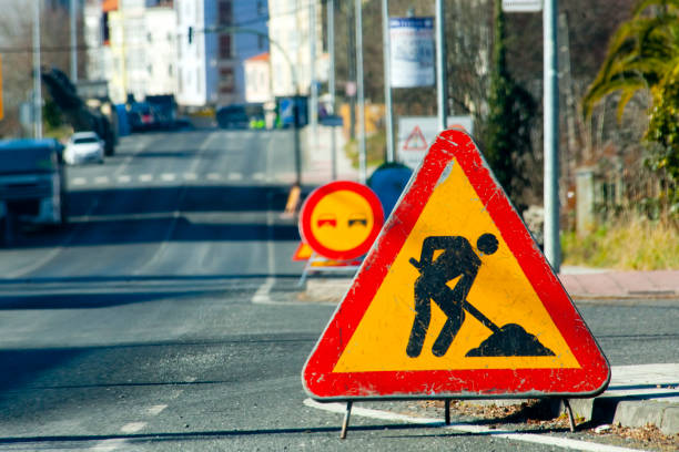 Road work ahead sign, urban road, danger ahead warning . stock photo