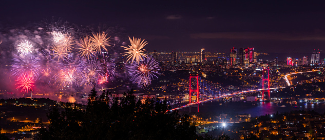 Fireworks over Istanbul Bosphorus during Turkish Republic Day celebrations. Fireworks with 15th July Martyrs Bridge (Bosphorus Bridge). Istanbul, Turkey.