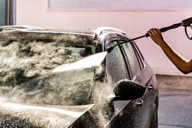 istock Man Washing Car at Carwash 1437748008
