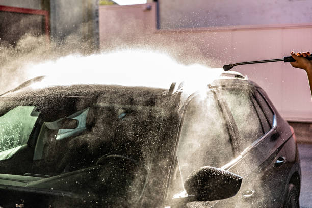 istock Man Washing Car at Carwash 1437748029