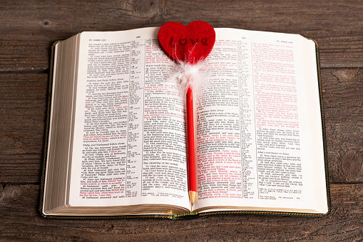 Bible and pencil with heart