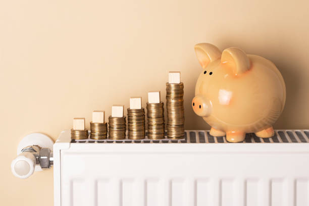 istock Piggy bank and coins on a radiator 1437748389