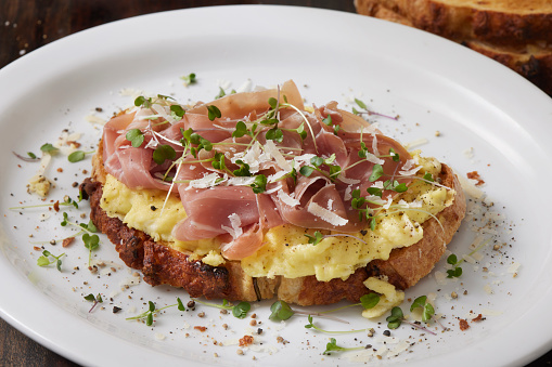 Scrambled Eggs and Prosciutto on Toasted Sourdough with Micro Greens