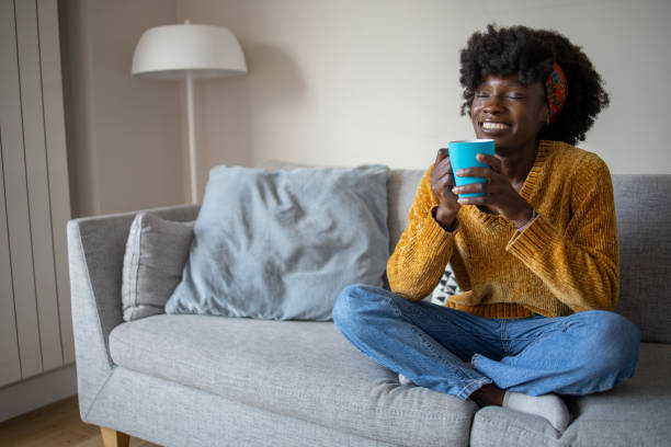 istock Beautiful woman relaxing and drinking hot tea 1437753516