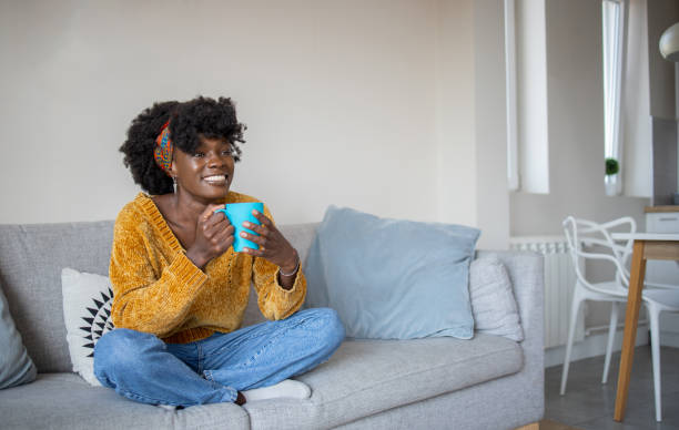 istock Woman having coffee and relaxing at home 1437753530