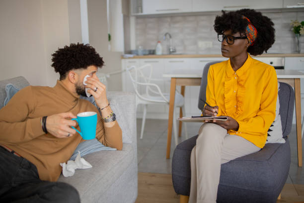 istock Young man having a therapeutic session with a psychologis 1437755346