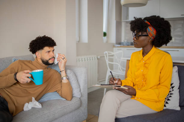 istock Young man having a therapeutic session with a psychologis 1437755353