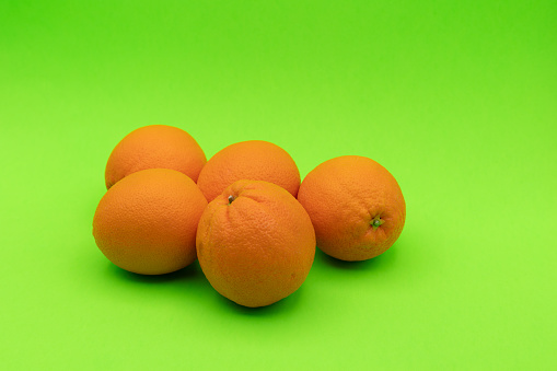 ORANGES ON A LIGHT GREEN BACKGROUND