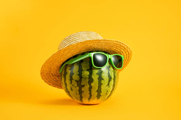 istock Watermelon with sunglasses and a straw hat on 1437757155