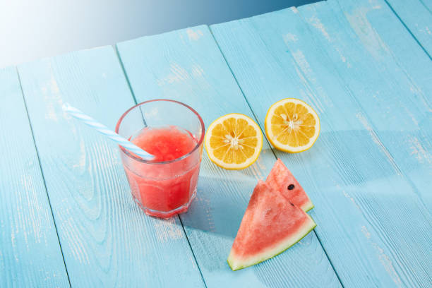 istock High angle shot of watermelon, juice, and oranges on a blue surface 1437757310
