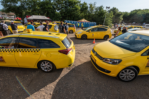 Budapest, Hungary - August 04 2019: Lots of yellow taxis picking up passengers after a sports event.