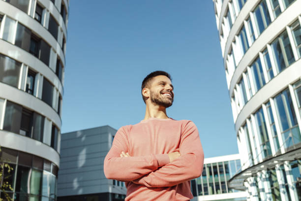 istock Confident young man standing with his arms crossed 1437758641