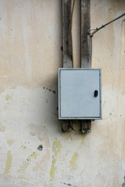 istock Old house electric panel, electric panel hanging on the old and abandoned building exterior 1437761577