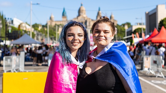 BARCELONA, Spain – June 25, 2022: Barcelona, Spain: June 25, 2022: A couple of bisexual girls enjoying themselves at the gay pride, lgbt party in Barcelona.