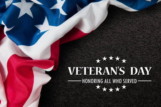 Closeup of American flag with Text Veterans Day Honoring All Who Served on black textured background. Closeup of American flag with Text Veterans Day Honoring All Who Served on black textured background. American holiday banner. thank you veterans day stock pictures, royalty-free photos & images