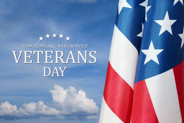 istock American flags with Text Veterans Day Honoring All Who Served on blue sky background. 1437763562