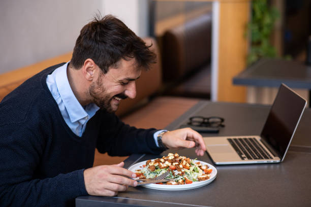 istock Smiling young man enjoying his lunch break by himself 1437764839
