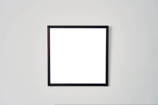 istock An empty square photo frame with a black border hanging on a white wall 1437765035