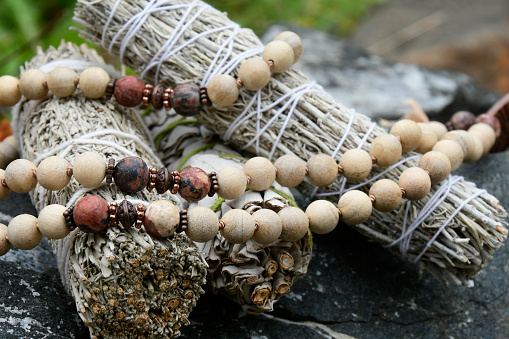 White sage smudge sticks with wooden prayer beads.