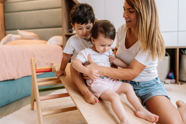 istock Mother playing with toddlers 1437772375