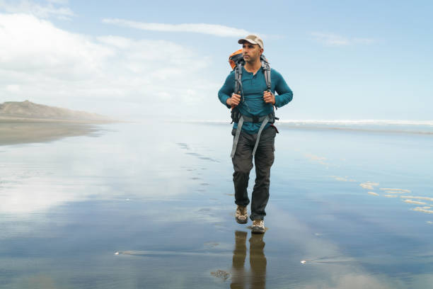 istock Man with backpack on beach, travel and holidays concept. 1437780476