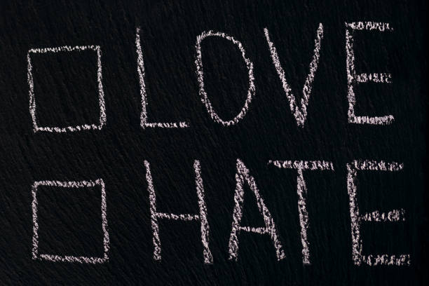 istock Writing in chalk on a rough board or asphalt love hate with checkmark option 1437781185