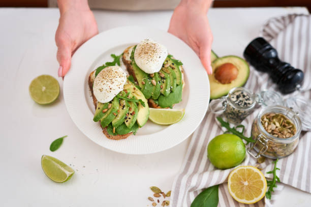 istock Freshly made poached egg and Avocado toasts on light grey background 1437781320