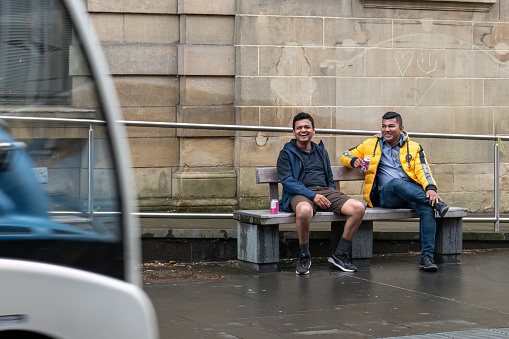 22 October 2022. Perth, Tayside, Scotland. This is two men sitting and having fun and laughing in Perth City Centre