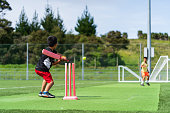 istock Kids loving the game of cricket. 1437784048