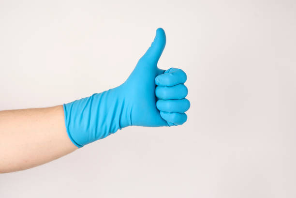 istock Hand in blue rubber glove showing thumb up 1437790339