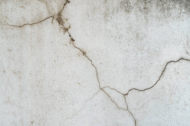 istock Old concrete stone wall covered with cracked plaster and dirty grunge textured surface. 1437790835