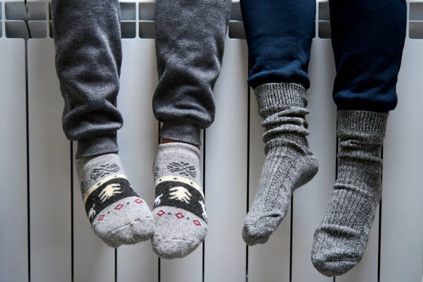 istock Warming feet on heater, close-up. Woman warming her Feet 1437793088