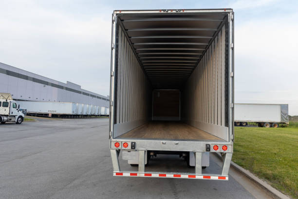 istock Empty semi-truck trailer in warehouse 1437796344