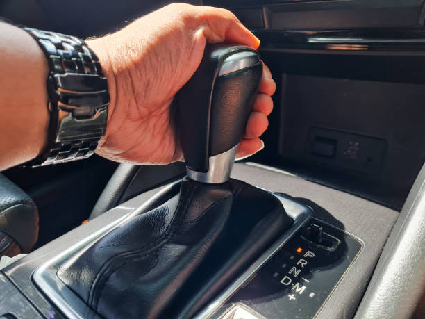 istock Asian man holding handle to gear stick lever Start driving vehicle.  automatic transmission shift lever 1437796522