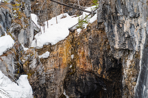 Rock textures and snow in a canyon