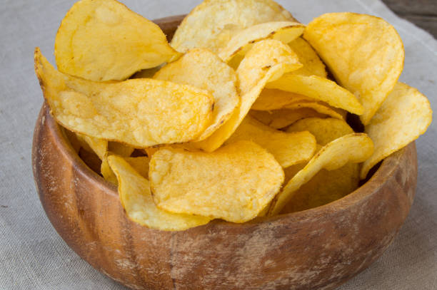istock Delicious crispy potato chips in an old wooden bowl 1437798439