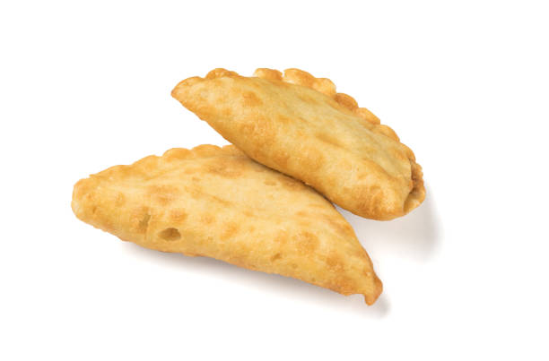 istock Two fresh, delicious meat pies isolated on a white background. 1437798519