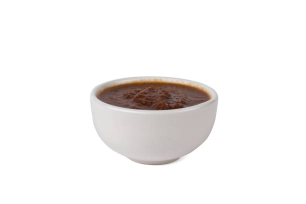 istock Red sauce in a white bowl isolated on a white background. 1437798521