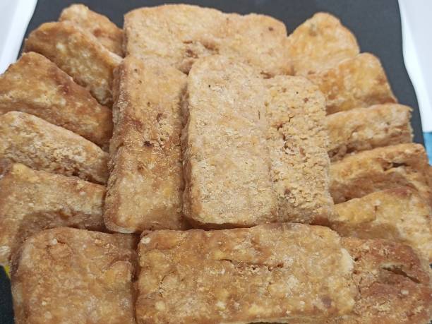 istock Tempe fried flour on a plate Isolated on Black Background. 1437799096