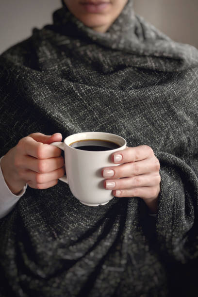 istock holding a cup of coffee 1437799403