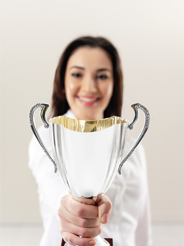 Businesswoman holding a trophy