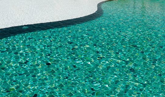 The water waves in the swimming pool were streaks of bright blue and saw the green tile pattern on the pool floor