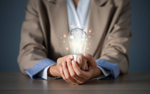 istock closeup businesswoman hand holding brightly light bulb 1437806570