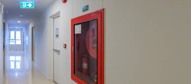 istock Fire extinguisher system on the wall with Fire Exit door sign for emergency. Stairwell fire for escape in building or apartment 1437809039