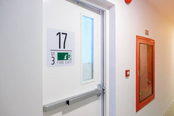 istock Fire extinguisher system on the wall with Fire Exit door sign for emergency. Stairwell fire for escape in building or apartment 1437809042
